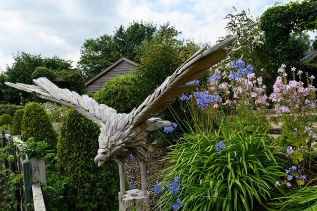 There are numerous sculptures and special features to see in the garden, which includes a raised pond,  herbaceous beds and a small vegetable growing area          Photo: Kelvin Stuttard