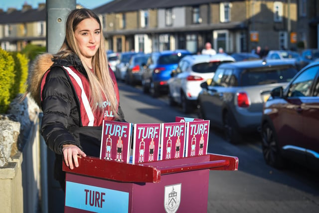 A young lady sells programmes outside Turf Moor 

Photographer Dave Howarth/CameraSport 

The Premier League - Burnley v Southampton - Thursday 21st April 2022 - Turf Moor - Burnley