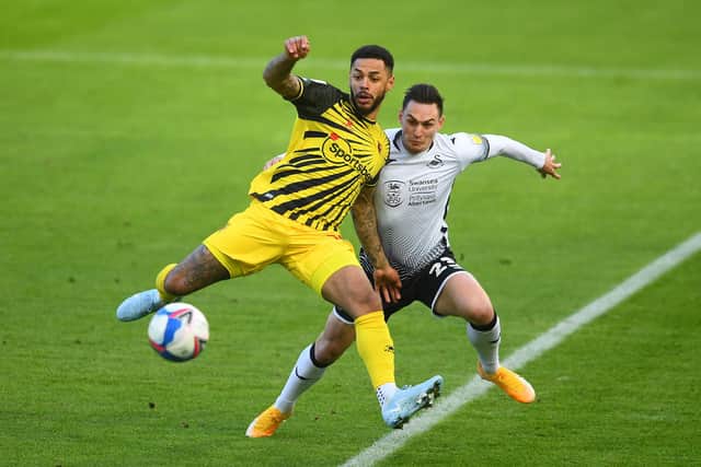 SWANSEA, WALES - JANUARY 02: Andre Gray of Watford is tackled by Connor Roberts of Swansea City during the Sky Bet Championship match between Swansea City and Watford at Liberty Stadium on January 02, 2021 in Swansea, Wales.  The match will be played without fans, behind closed doors as a Covid-19 precaution. (Photo by Harry Trump/Getty Images)