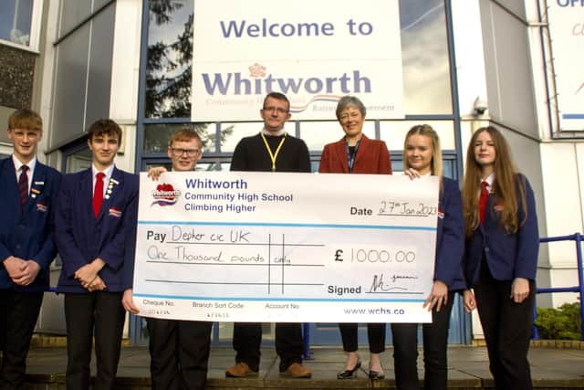 Whitworth High School students present James Anderson of Depher with a cheque