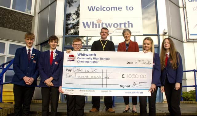 Whitworth High School students present James Anderson of Depher with a cheque