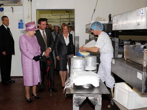 Queen Elizabeth II pictured with brother and sister Bill Riding and Tilly Carefoot watching the cheese making process during the royal visit to Singleton's Dairy in June 2008.