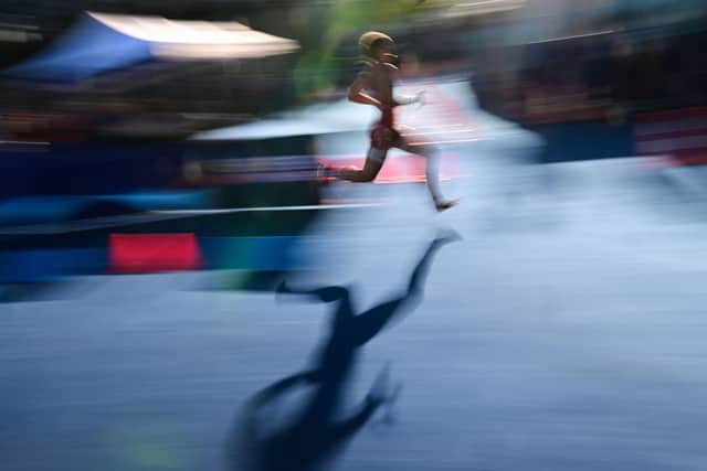 Image of an elite athlete competing in a relay race. (Photo by ANDREJ ISAKOVIC/AFP via Getty Images)