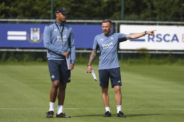 Anderlecht's head coach Vincent Kompany talks to Anderlecht's assistant coach Craig Bellamy during a training session of RSCA Anderlecht, ahead of the return leg of the third qualification round of the Conference League European competition between Albanian club KF Laci and Belgian soccer team RSC Anderlecht, on August 11, 2021 in Anderlecht. - - Belgium OUT (Photo by JOHN THYS / BELGA / AFP) / Belgium OUT (Photo by JOHN THYS/BELGA/AFP via Getty Images)