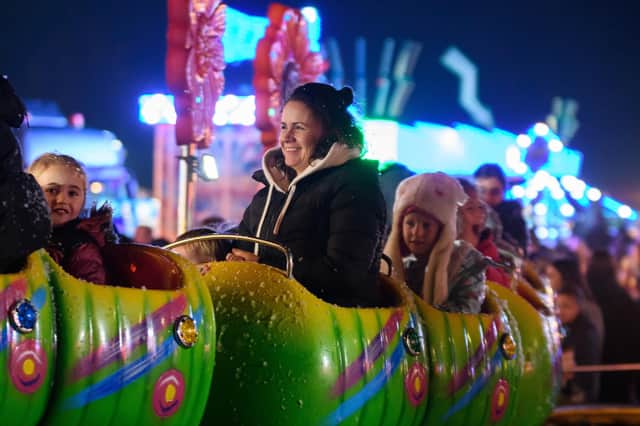Children and adults enjoying the rides at Towneley Park's bonfire and fireworks night. Photo: Kelvin Stuttard