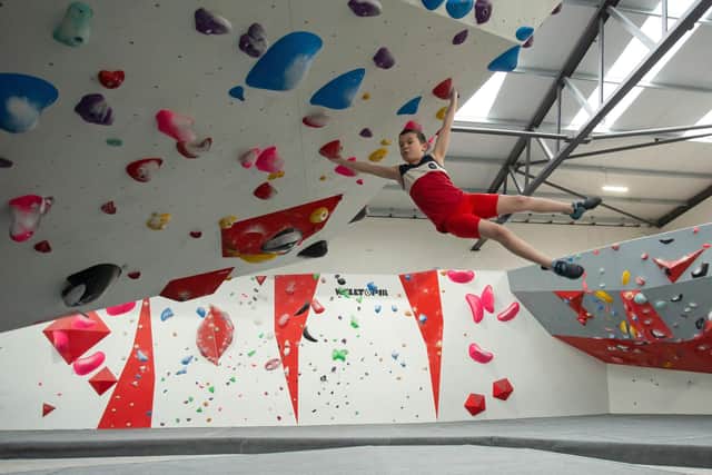Alexander demonstrating his winning techniques on the LancasterWall bouldering wall.