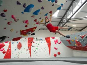 Alexander demonstrating his winning techniques on the LancasterWall bouldering wall.