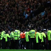 PRESTON, UNITED KINGDOM - APRIL 22:  Police and stewards stand in front of the supporters of Burnley during the Sky Bet Championship match between Preston North End and Burnley at Deepdale on April 22, 2016 in Preston, England.  (Photo by Alex Livesey/Getty Images)