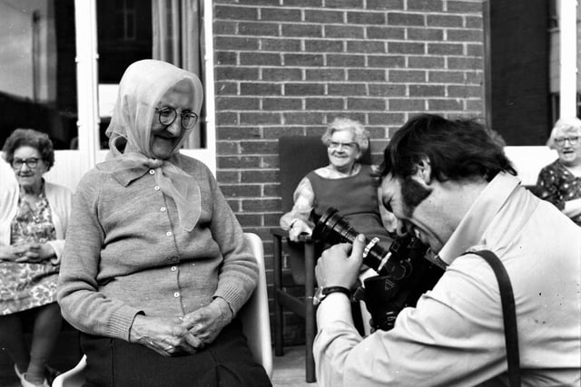 Granada cameraman Mike Blakeley takes a shot of the oldest Holly House resident, Mrs Minnie Ingham.
A television film unit from Granada visited a model housing complex for the aged - in Holmes Street, Burnley - on Thursday 29th May 1971