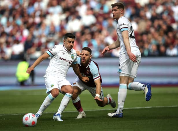 LONDON, ENGLAND - APRIL 17: Mathew Lowton of Burnley clears the ball away from Nikola Vlasic of West Ham United during the Premier League match between West Ham United and Burnley at London Stadium on April 17, 2022 in London, England. (Photo by Steve Bardens/Getty Images)