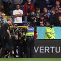 BURNLEY, ENGLAND - AUGUST 11: A spectator (whose face has been blurred) is arrested by the police after attempting to run on the pitch during the Premier League match between Burnley FC and Manchester City at Turf Moor on August 11, 2023 in Burnley, England. (Photo by Nathan Stirk/Getty Images)
