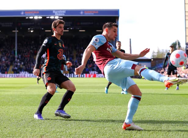 BURNLEY, ENGLAND - MARCH 05: Ashley Westwood of Burnley clears the ball from Mason Mount of Chelsea during the Premier League match between Burnley and Chelsea at Turf Moor on March 05, 2022 in Burnley, England. (Photo by Alex Livesey/Getty Images)