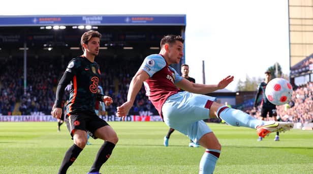 BURNLEY, ENGLAND - MARCH 05: Ashley Westwood of Burnley clears the ball from Mason Mount of Chelsea during the Premier League match between Burnley and Chelsea at Turf Moor on March 05, 2022 in Burnley, England. (Photo by Alex Livesey/Getty Images)