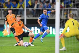 LODZ, POLAND - JUNE 14: Vitaliy Mykolenko of Ukraine has a shot on goal whilst under pressure from Nathan Collins of Republic of Ireland during the UEFA Nations League - League B Group 1 match between Ukraine and Republic of Ireland at LKS Stadium on June 14, 2022 in Lodz, Poland. (Photo by Adam Nurkiewicz/Getty Images)