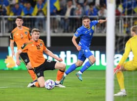 LODZ, POLAND - JUNE 14: Vitaliy Mykolenko of Ukraine has a shot on goal whilst under pressure from Nathan Collins of Republic of Ireland during the UEFA Nations League - League B Group 1 match between Ukraine and Republic of Ireland at LKS Stadium on June 14, 2022 in Lodz, Poland. (Photo by Adam Nurkiewicz/Getty Images)