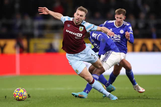 BURNLEY, ENGLAND - MARCH 01: Charlie Taylor of Burnley is challenged by Patson Daka of Leicester City during the Premier League match between Burnley and Leicester City at Turf Moor on March 01, 2022 in Burnley, England.