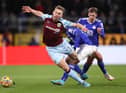 BURNLEY, ENGLAND - MARCH 01: Charlie Taylor of Burnley is challenged by Patson Daka of Leicester City during the Premier League match between Burnley and Leicester City at Turf Moor on March 01, 2022 in Burnley, England.