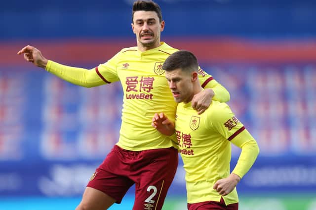 LONDON, ENGLAND - FEBRUARY 13: Johann Gudmundsson of Burnley celebrates with teammate Matthew Lowton after scoring his team's first goal during the Premier League match between Crystal Palace and Burnley at Selhurst Park on February 13, 2021 in London, England. (Photo by Julian Finney/Getty Images)