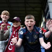 BURNLEY, ENGLAND - APRIL 24: Young Burnley fans celebrate their side's win after the final whistle of the Premier League match between Burnley and Wolverhampton Wanderers at Turf Moor on April 24, 2022 in Burnley, England. (Photo by Gareth Copley/Getty Images)
