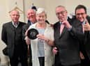 Katie Lancaster with The Barron Knights and the record she dug out from her loft to auction in a bid to raise cash for Ukraine