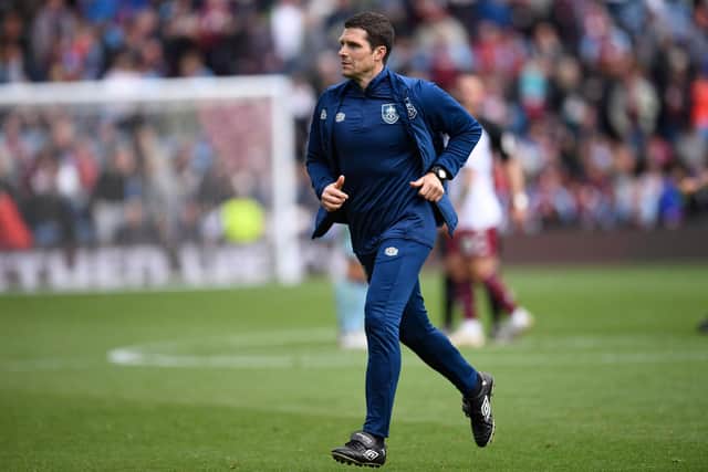 Burnley's interim manager Mike Jackson runs off at half time in the English Premier League football match between Burnley and Aston Villa at Turf Moor in Burnley, north west England on May 7, 2022.