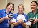 Macmillan gynaecological Cancer Nurse Specialist Lisa Nicholson (left) and fellow gynae-oncology nurses Rachel Webster (centre) and Beth Nield with the cards that could help women re-access their services with minimum delay