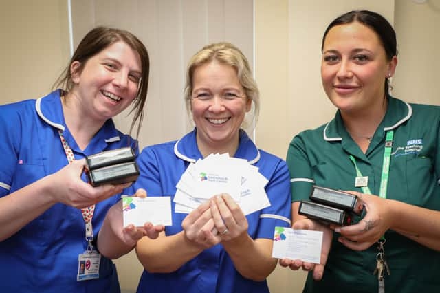 Macmillan gynaecological Cancer Nurse Specialist Lisa Nicholson (left) and fellow gynae-oncology nurses Rachel Webster (centre) and Beth Nield with the cards that could help women re-access their services with minimum delay