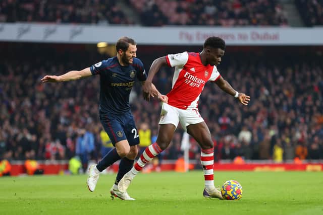 LONDON, ENGLAND - JANUARY 23: Bukayo Saka of Arsenal is put under pressure by Erik Pieters of Burnley during the Premier League match between Arsenal and Burnley at Emirates Stadium on January 23, 2022 in London, England. (Photo by Catherine Ivill/Getty Images)