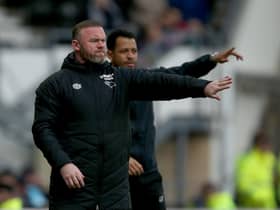 DERBY, ENGLAND - APRIL 23: Wayne Rooney (L) manager of Derby County during the Sky Bet Championship match between Derby County and Bristol City at Pride Park Stadium on April 23, 2022 in Derby, England. (Photo by Nigel Roddis/Getty Images)
