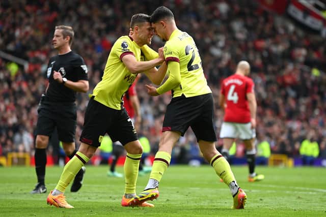 MANCHESTER, ENGLAND - APRIL 27: Zeki Amdouni of Burnley celebrates scoring his team's first goal with teammate Johann Gudmundsson during the Premier League match between Manchester United and Burnley FC at Old Trafford on April 27, 2024 in Manchester, England. (Photo by Gareth Copley/Getty Images)