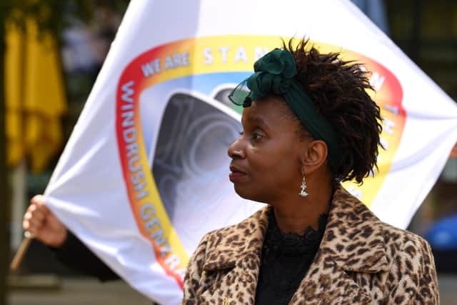 Glenda Andrew, who has been awarded the BEM, pictured with Windrush flag