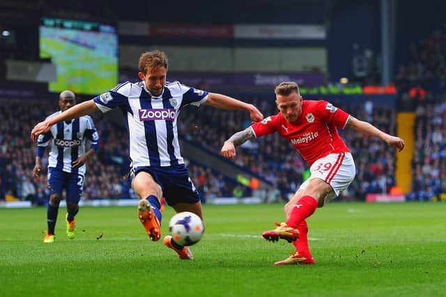 WEST BROMWICH, ENGLAND - MARCH 29: Craig Dawson of West Brom  attempts to block the cross of Craig Bellamy of Cardiff City  during the Barclays Premier League match between West Bromwich Albion and Cardiff City at The Hawthorns on March 29, 2014 in West Bromwich, England.  (Photo by Laurence Griffiths/Getty Images)