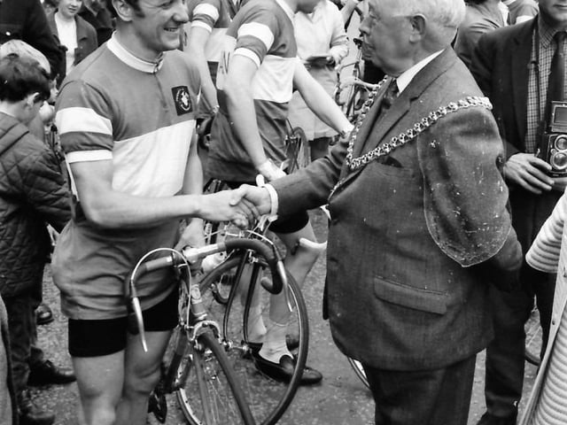 A cheering crowd of about 250 people outside Burnley Town Hall greeted riders in the NE Lancashire Samaritans' Round Britain Cycle Race. The Mayor congratulates Burnley rider David Wilkinson.