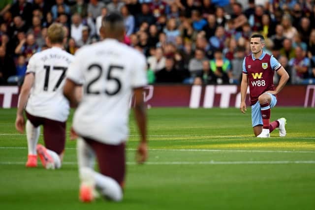 BURNLEY, ENGLAND - AUGUST 11: Josh Cullen of Burnley takes a knee prior to the Premier League match between Burnley FC and Manchester City at Turf Moor on August 11, 2023 in Burnley, England. (Photo by Michael Regan/Getty Images)