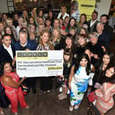 Guests at the ladies' day event, organised by CARES charity and held at Burnley's Penny Black, with the cheque for £250,000 to purchase vital equipment for the ELHT