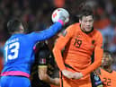 Gibraltar's goalkeeper Bradley Banda (L) punches the ball past Netherlands' forward Wout Weghorst during the FIFA World Cup Qatar 2022 qualification group G football match between The Netherlands and Gibraltar at De Kuip stadium, in Rotterdam, on October 11, 2021. (Photo by JOHN THYS / AFP) (Photo by JOHN THYS/AFP via Getty Images)