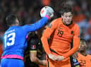 Gibraltar's goalkeeper Bradley Banda (L) punches the ball past Netherlands' forward Wout Weghorst during the FIFA World Cup Qatar 2022 qualification group G football match between The Netherlands and Gibraltar at De Kuip stadium, in Rotterdam, on October 11, 2021. (Photo by JOHN THYS / AFP) (Photo by JOHN THYS/AFP via Getty Images)