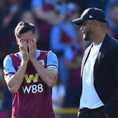 Burnley's English midfielder #04 Jack Cork reacts next to Burnley's Belgian manager Vincent Kompany at the end of the English Premier League football match between Burnley and Nottingham Forest at Turf Moor in Burnley, north-west England on May 19, 2024. (Photo by ANDY BUCHANAN / AFP)