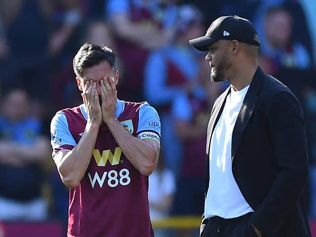 Burnley's English midfielder #04 Jack Cork reacts next to Burnley's Belgian manager Vincent Kompany at the end of the English Premier League football match between Burnley and Nottingham Forest at Turf Moor in Burnley, north-west England on May 19, 2024. (Photo by ANDY BUCHANAN / AFP)