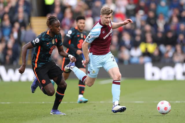 BURNLEY, ENGLAND - MARCH 05: Nathan Collins of Burnley is challenged by Trevoh Chalobah of Chelsea during the Premier League match between Burnley and Chelsea at Turf Moor on March 05, 2022 in Burnley, England. (Photo by Lewis Storey/Getty Images)