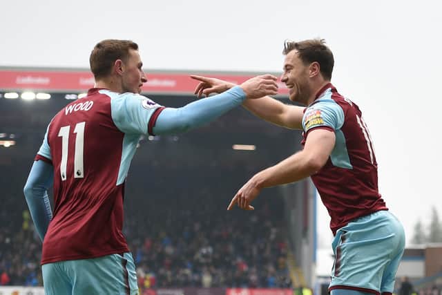 Burnley's New Zealand striker Chris Wood (L) congratulates Burnley's English striker Ashley Barnes on scoring their first goal during the English Premier League football match between Burnley and Everton at Turf Moor in Burnley, north west England on March 3, 2018.