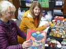 Beverly Holmes (left) adds the Advent Calendars to food parcels made up at St Leonard’s Church, Padiham, with volunteer helper, Heather Whitham, president of the Padiham Rotary Club