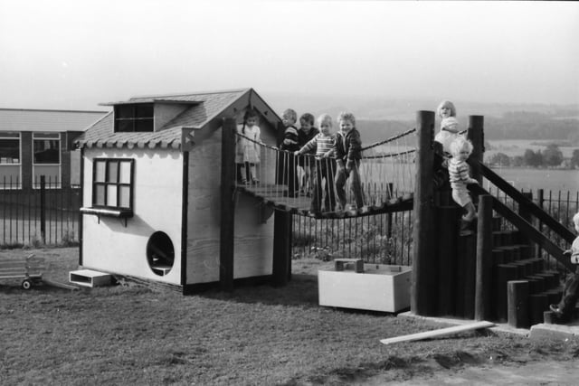 Youngsters of Brunshaw Nursery and family Centre, Morse Street, enjoy their new Wendy House and swing bridge which had been built by recruits to the Youth Opportunities Scheme.