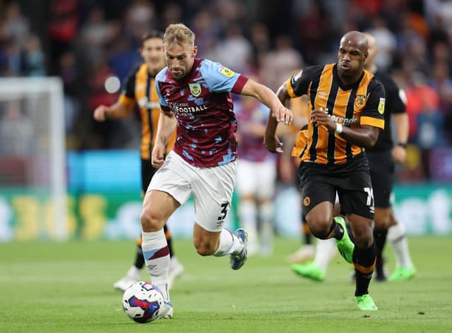 BURNLEY, ENGLAND - AUGUST 16: Charlie Taylor of Burnley is challenged by Oscar Estupinan of Hull City during the Sky Bet Championship between Burnley and Hull City at Turf Moor on August 16, 2022 in Burnley, England. (Photo by Clive Brunskill/Getty Images)