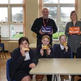 Warburton's Community Champion Gary Dugdale and Susan Layfield, breakfast club co-ordinator with pupils  at St Stephen's Primary School.
