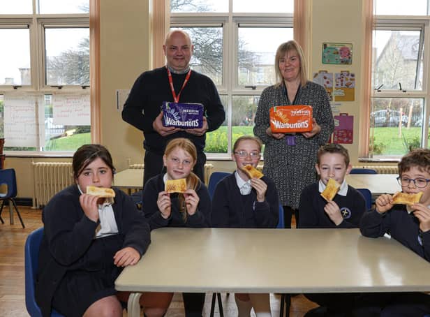 Warburton's Community Champion Gary Dugdale and Susan Layfield, breakfast club co-ordinator with pupils  at St Stephen's Primary School.