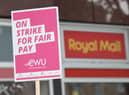 A sign held by a postal worker from the Communication Workers Union (CWU) on the picket line at a Royal Mail Delivery Office.Picture by James Manning/PA Wire
