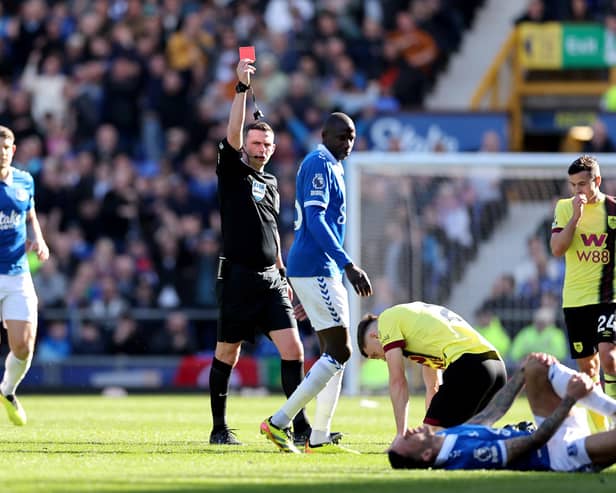 LIVERPOOL, ENGLAND - APRIL 06: Referee Michael Oliver gives a red card to Dara O'Shea of Burnley during the Premier League match between Everton FC and Burnley FC at Goodison Park on April 06, 2024 in Liverpool, England. (Photo by Jan Kruger/Getty Images) (Photo by Jan Kruger/Getty Images)