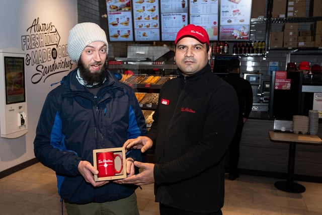 The first customer at Tim Hortons was Louis Gilbraith, who is pictured with Burnley restaurant manager Randhir Tomar. Photo: Kelvin Stuttard