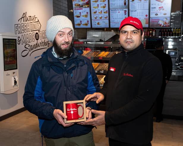 The first customer at Tim Hortons was Louis Gilbraith, who is pictured with Burnley restaurant manager Randhir Tomar. Photo: Kelvin Stuttard